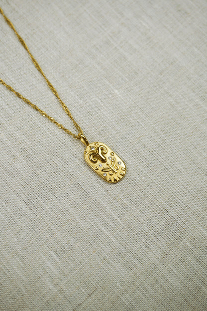 Gold thin dainty necklace with an aries zodiac pendant