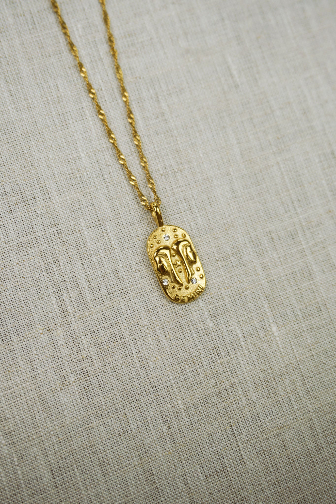 Gold thin dainty necklace with a gemini zodiac pendant