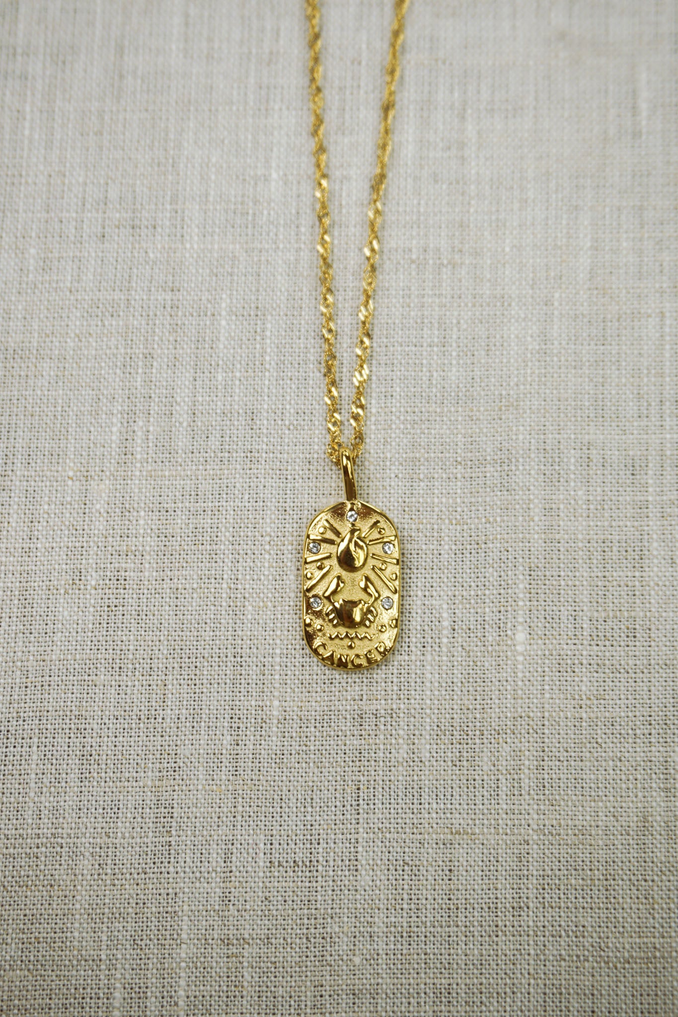 Gold thin dainty necklace with a cancer zodiac pendant