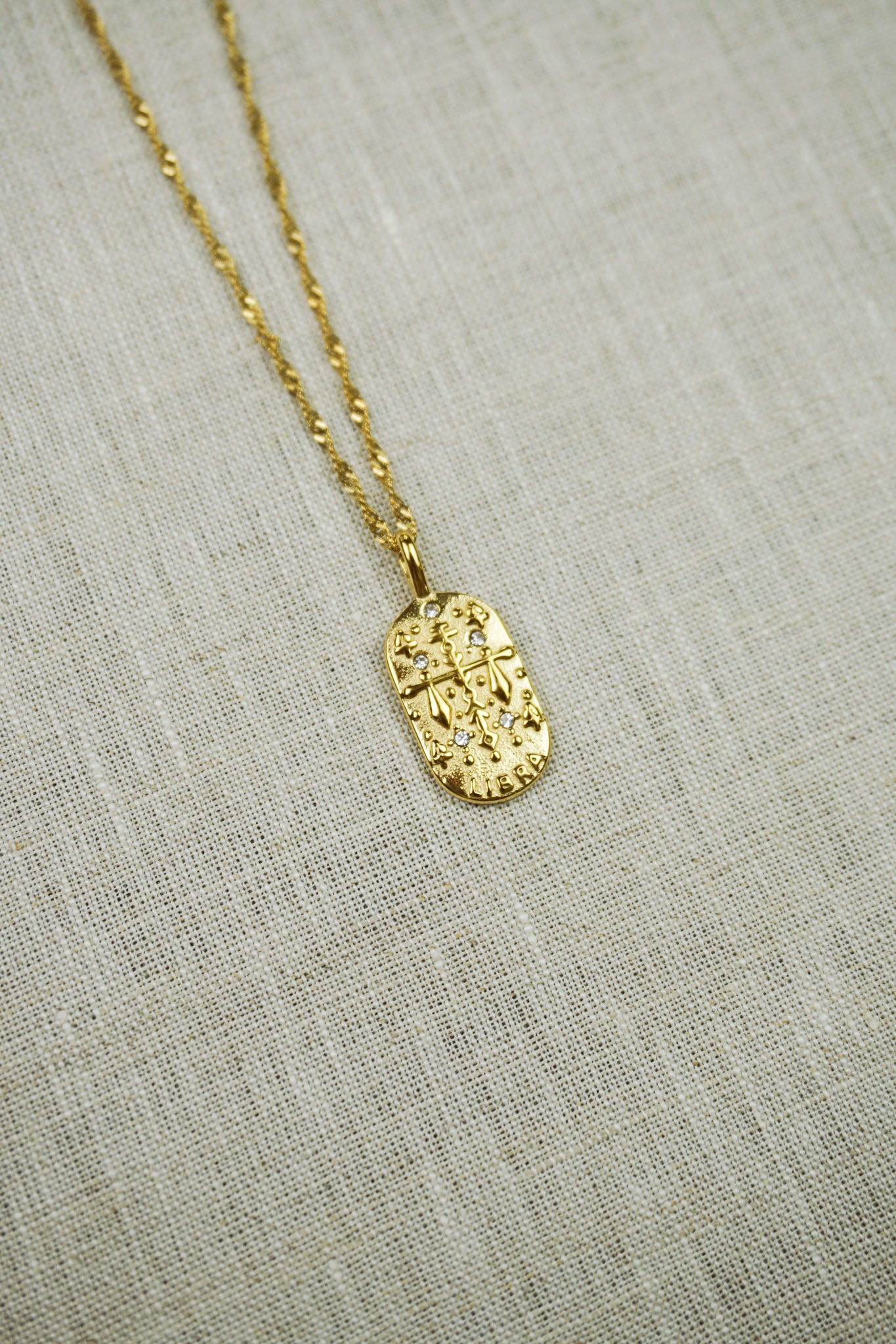 Gold thin dainty necklace with a libra zodiac pendant