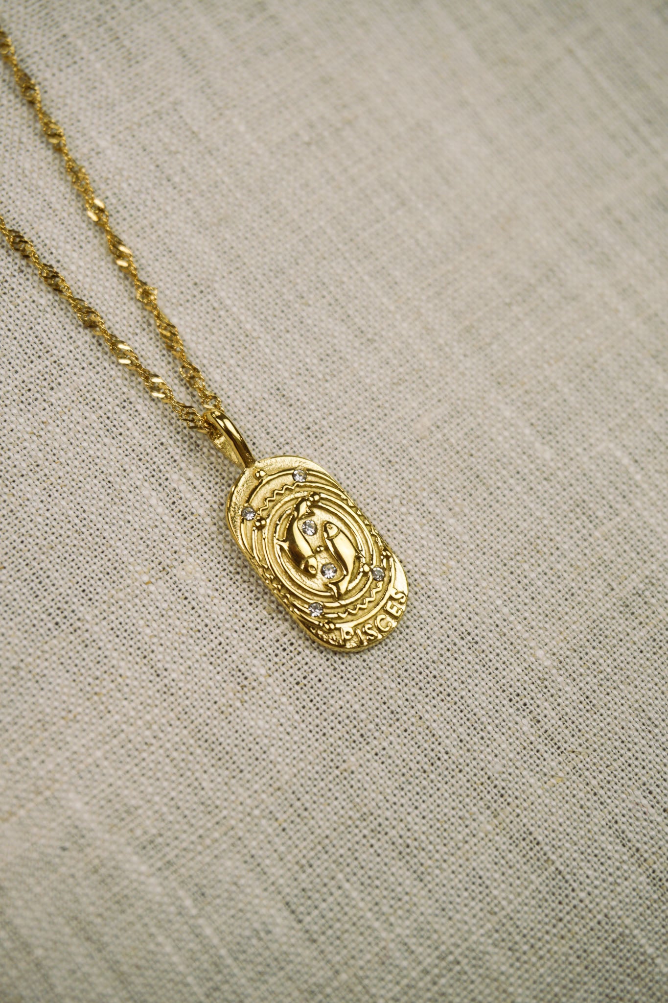 Gold thin dainty necklace with a pisces zodiac pendant