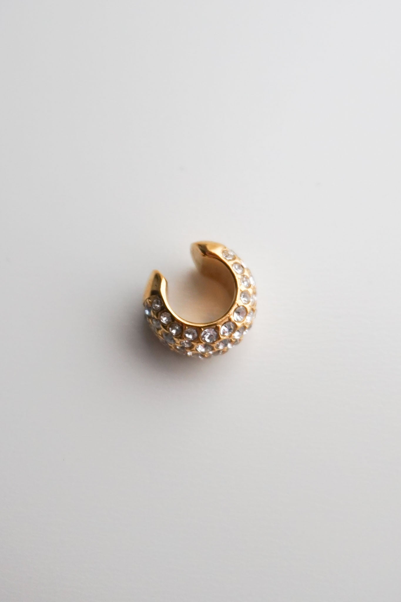 Gold cuff with embedded stones pavé diamonds