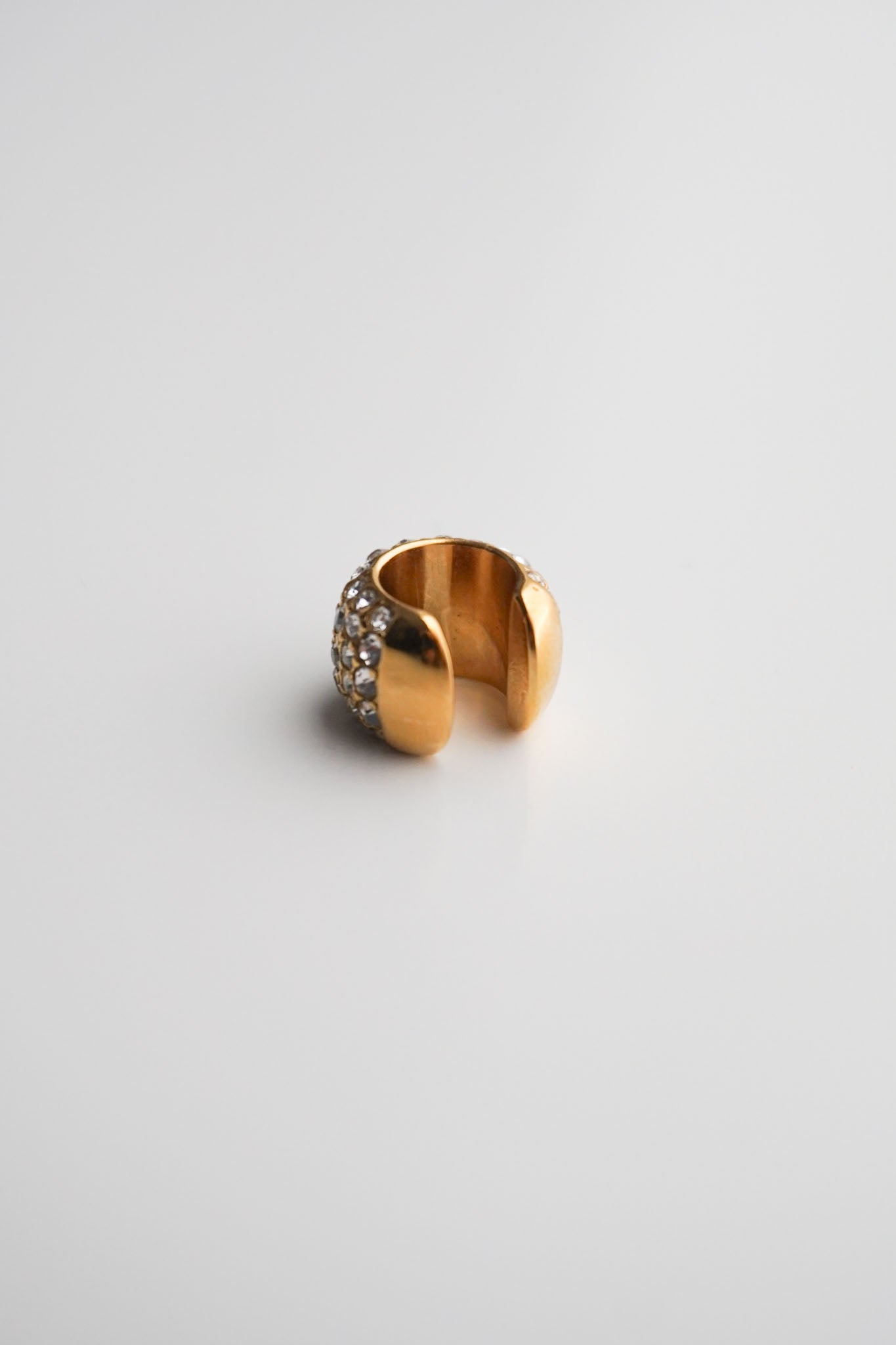 Gold cuff with embedded stones pavé diamonds