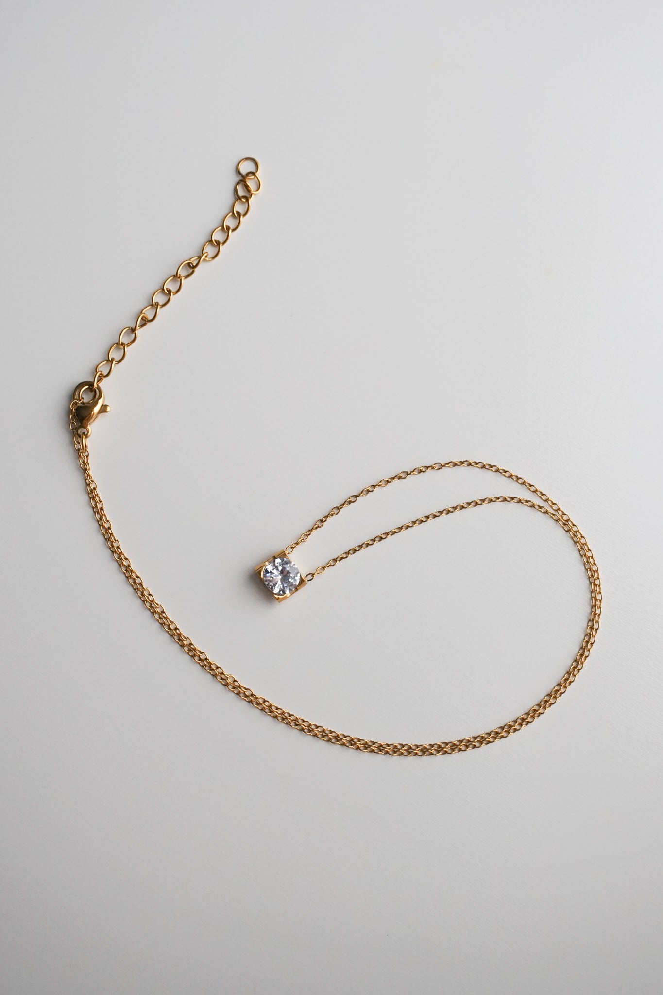 Gold necklace with a small diamond pendant
