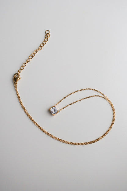 Gold necklace with a small diamond pendant