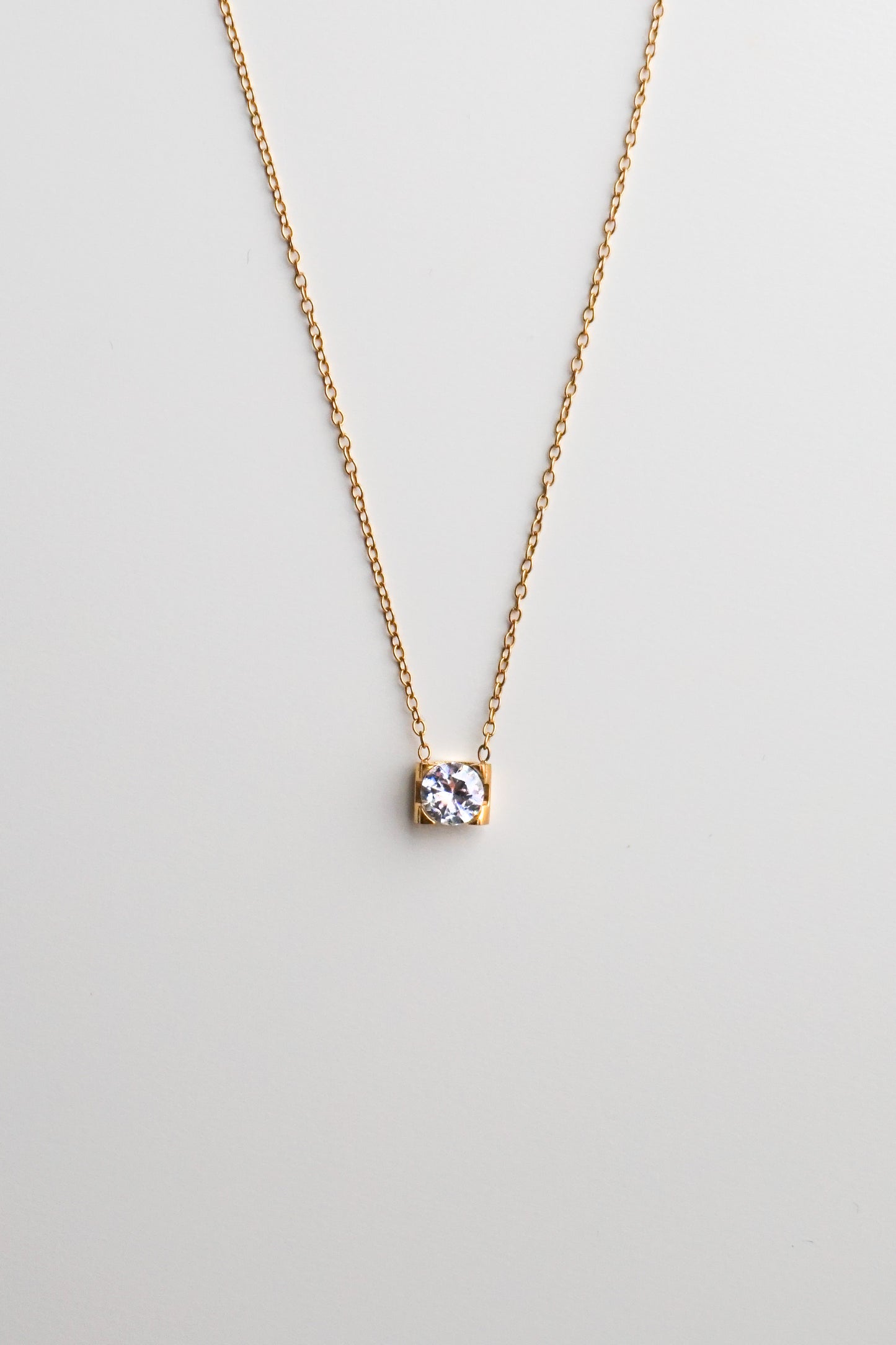 Gold necklace with a small diamond pendant