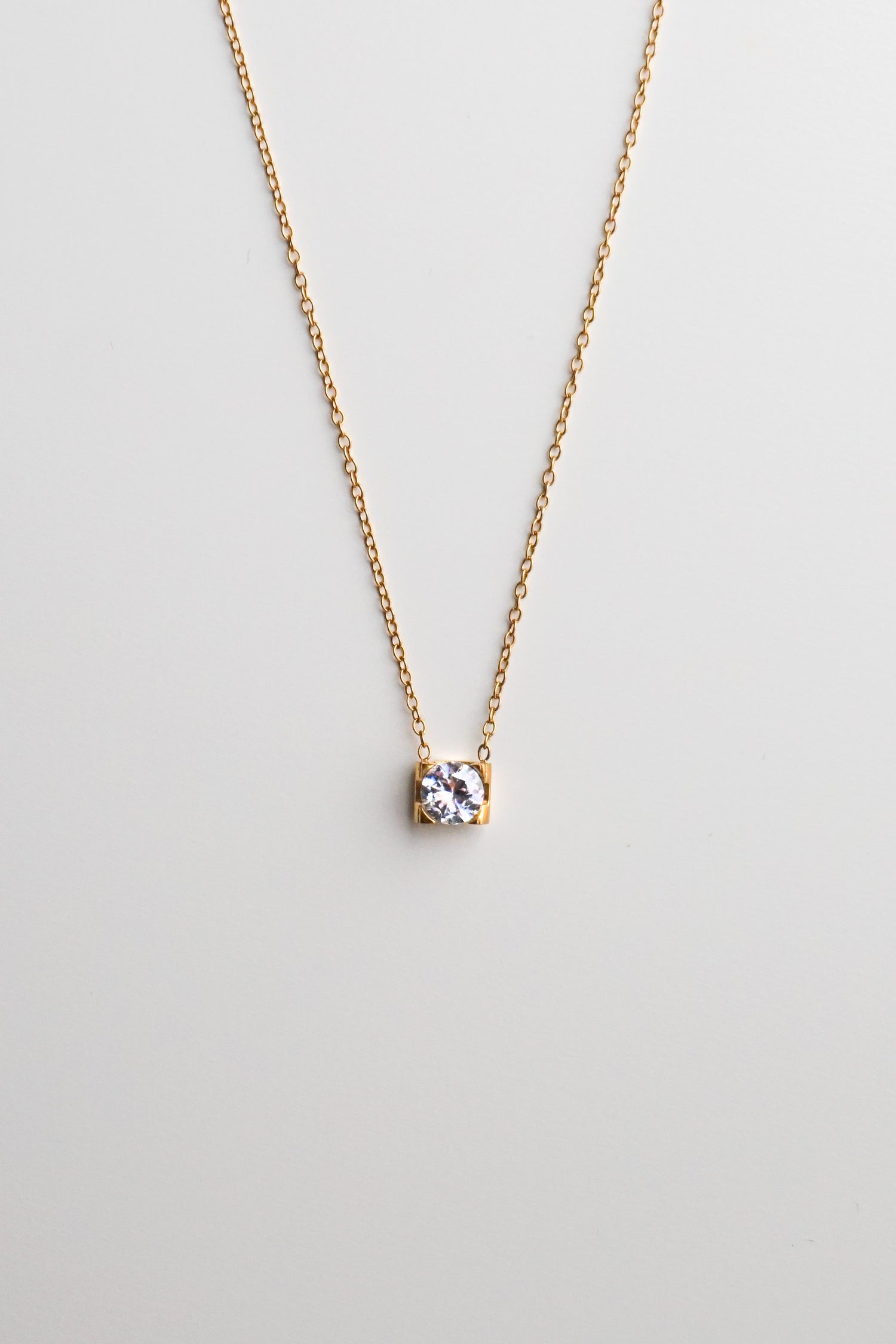 Gold necklace with a small diamond pendant